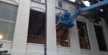 stained glass window restoration, vibrant colors, historical building exterior Houston