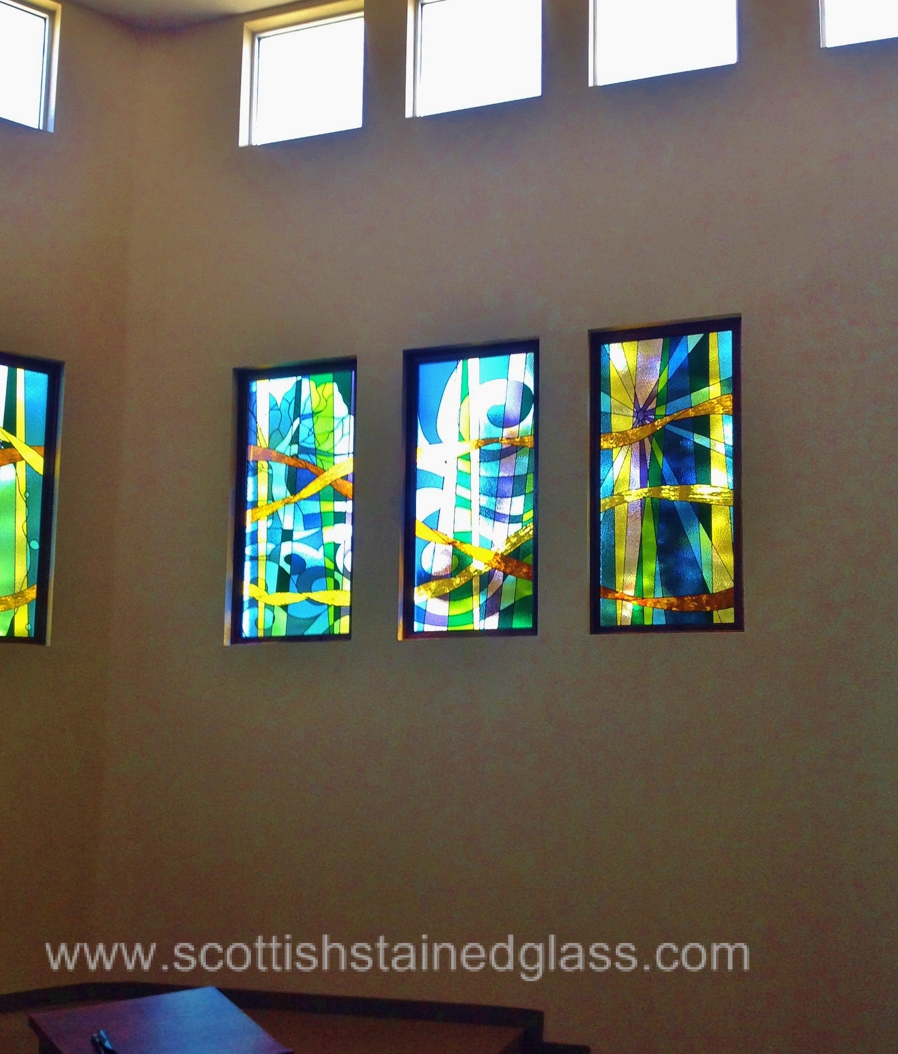 Houston church interior with vibrant stained glass windows depicting celestial scenes