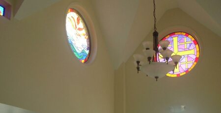 Houston chapel with stained glass windows, cracks visible, in sunlight